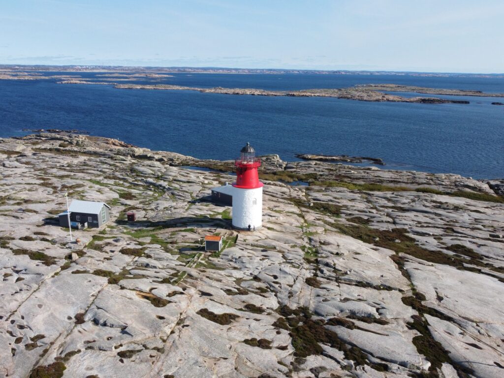 Aerial view of Hållö island, in the center the red and white lighthouse is seen.