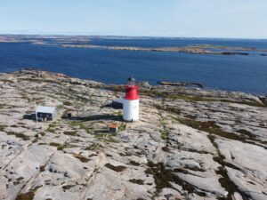Aerial view of Hållö island, in the center the red and white lighthouse is seen.