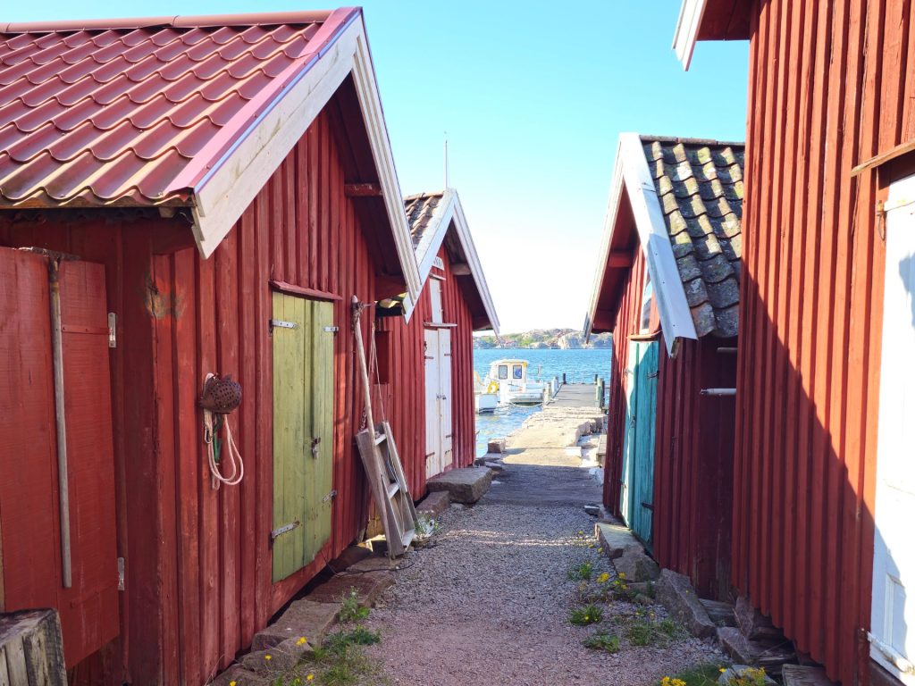 Traditional red wooden fishing huts along the waterfront in Bovallstrand.